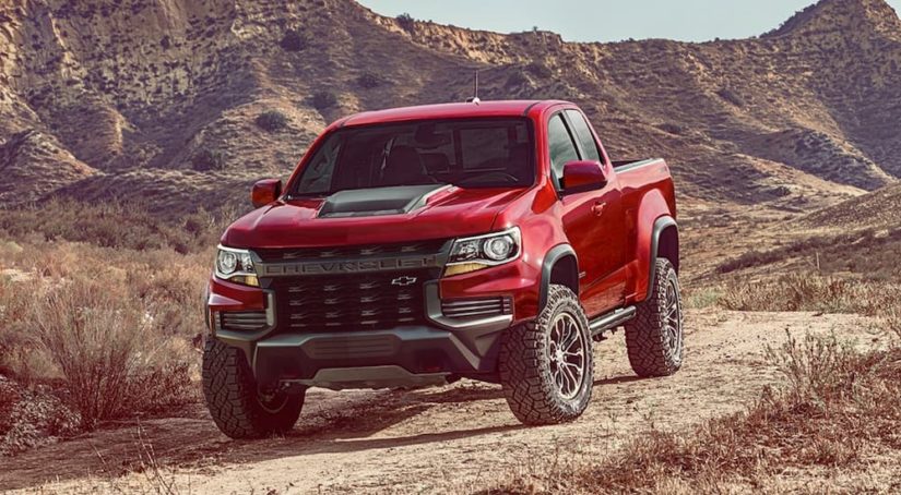 A red 2022 Chevy Colorado ZR2 is shown from the front at an angle in the desert after leaving a Chevy dealer near you.
