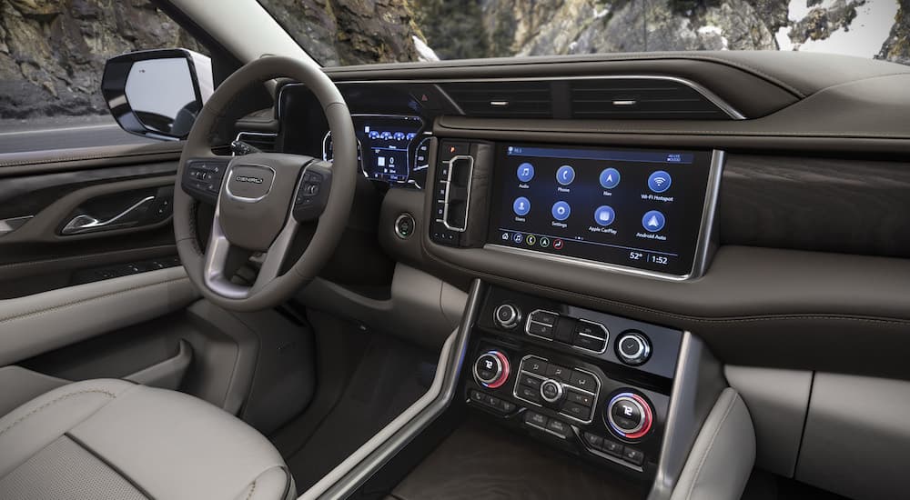 The interior of a 2022 GMC Yukon Denali is shown from the passenger seat.