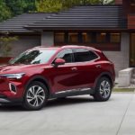 A red 2022 Buick Envision is shown parked outside of a modern home.
