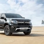A black 2022 Chevy Colorado Z71 Trailboss is shown on a beach during a 2022 Chevy Colorado vs 2022 Nissan Frontier comparison.