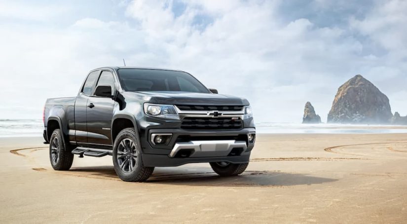 A black 2022 Chevy Colorado Z71 Trailboss is shown on a beach during a 2022 Chevy Colorado vs 2022 Nissan Frontier comparison.