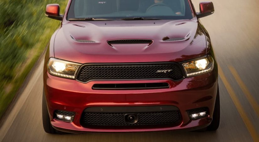 A red 2022 Dodge Durango SRT is shown from the front driving on an open road.