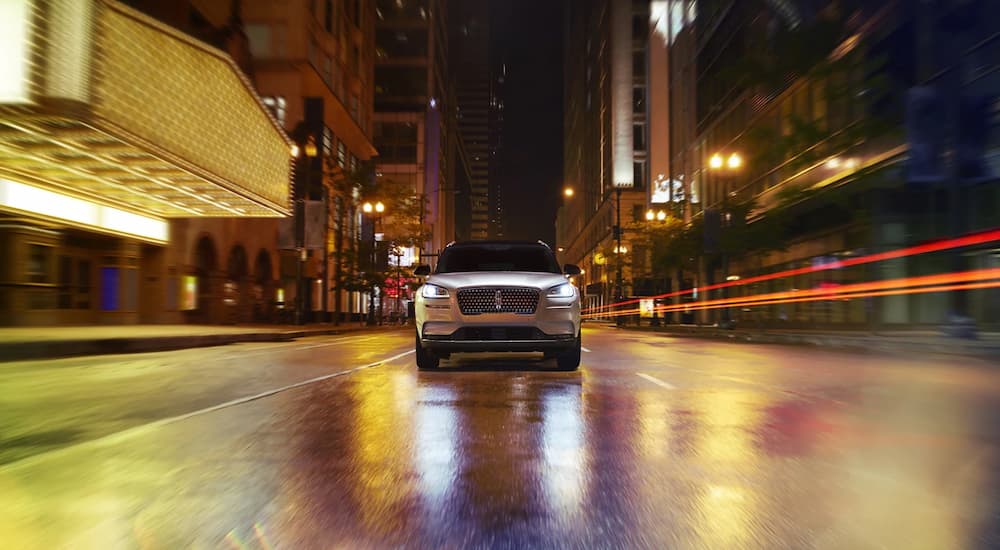 A silver 2022 Lincoln Corsair is shown from the front driving on a city street.