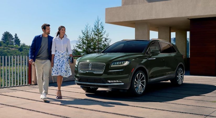 A green 2022 Lincoln Nautilus is shown parked in a driveway.