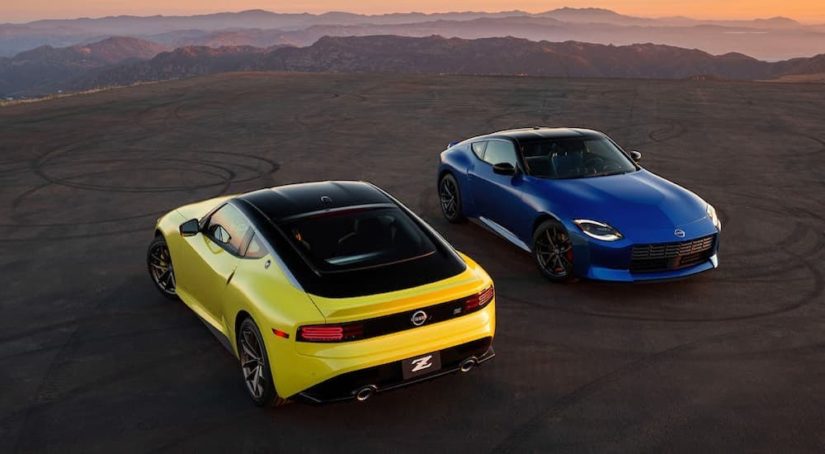 A yellow and a blue 2023 Nissan Z are shown facing opposite directions from a high angle after leaving a Nissan dealer in Minot.