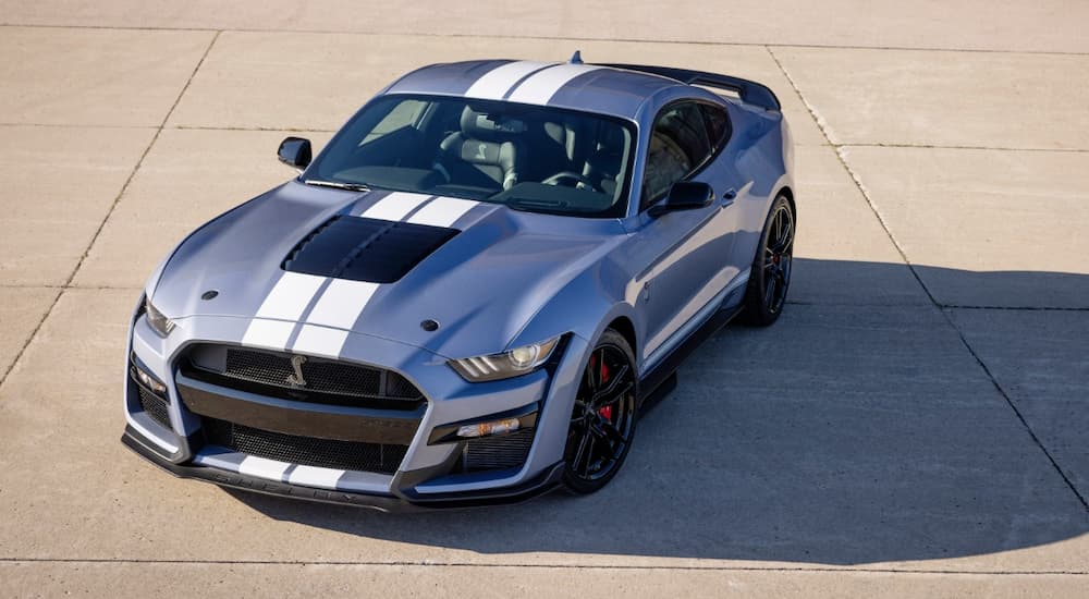A blue 2022 Ford Mustang Shelby GT500 Heritage Edition is shown parked in an empty lot.
