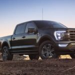 A black 2022 Ford F-150 Lariat is shown parked during a 2022 Ford F-150 vs 2022 Chevy Silverado 1500 competition.