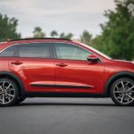 A red 2022 Kia Niro is shown from the side after leaving a Kia dealer.