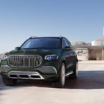 A dark green 2021 Mercedes-Maybach GLS is shown next to a modern house and an infinity pool.