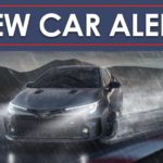 A grey 2023 Toyota GR Corolla is shown drifting in the rain below new car alert banner.