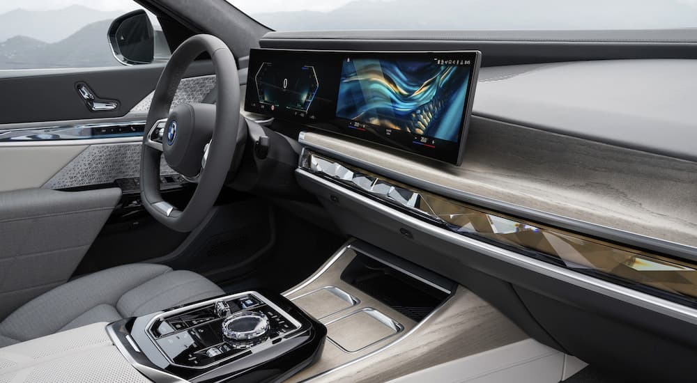 The interior of a 2023 BMW i7 is shown from the passenger seat.