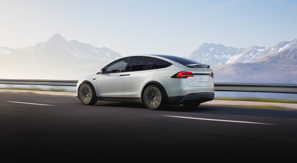 A white Tesla Model X is shown from the side