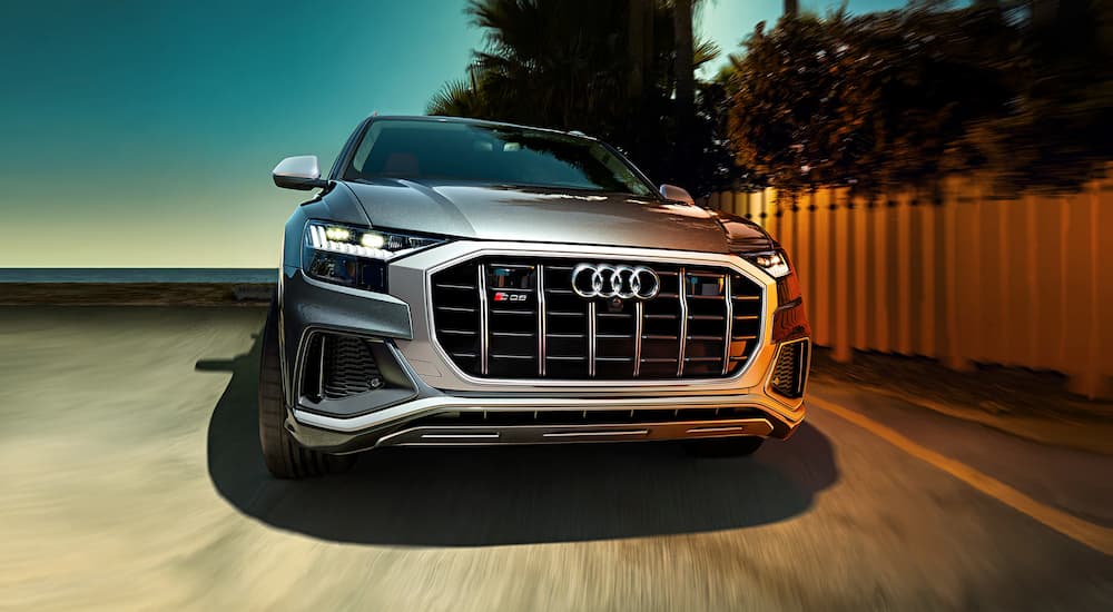 A close up of the front of a 2021 Audi Q8 is shown driving on a street.