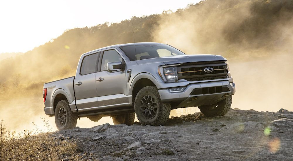 A Silver 2022 Ford F-150 Tremor is shown from the front at an angle while parked off-road during a 2022 Chevy Silverado 1500 vs 2022 Ford F-150 comparison.