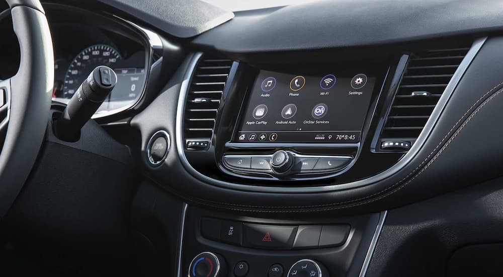 The black interior of a 2022 Chevy Trax shows the infotainment screen.