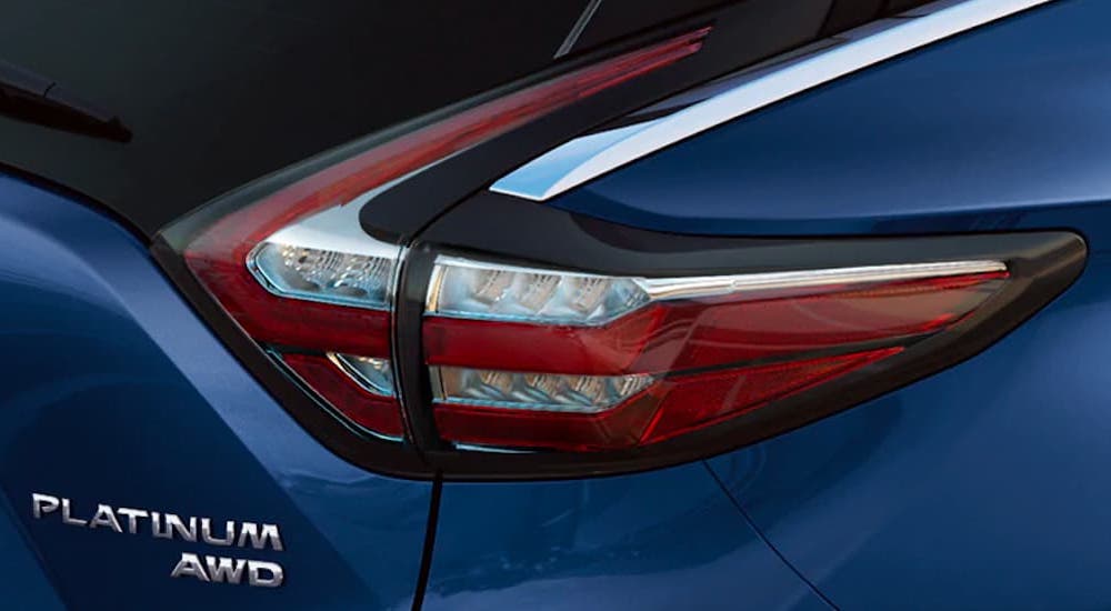 A close up shows the passenger taillight and badging on a blue 2022 Nissan Murano Platinum.