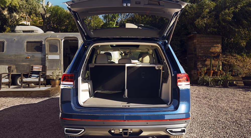 A blue 2022 Volkswagen Atlas is shown with an open liftgate.