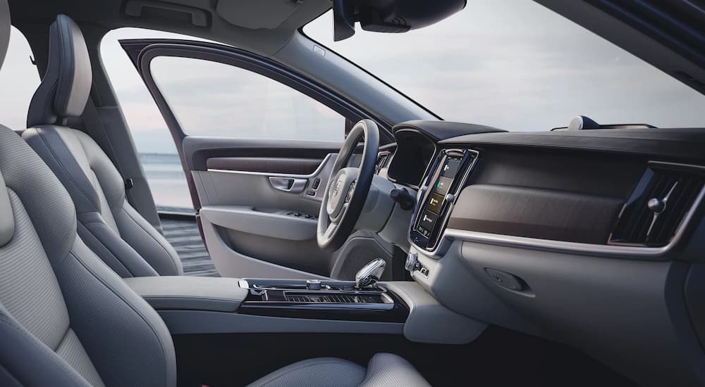 The grey and black interior of a 2022 Volvo S90 is shown from the passenger side seat.