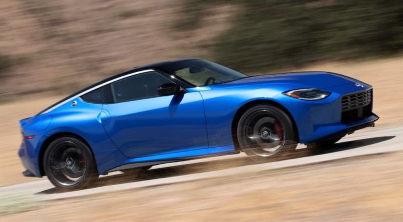 A blue 2023 Nissan Z is shown from the side while at speed.
