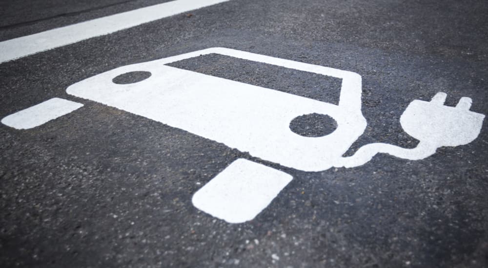 An electric vehicle parking spot logo is shown.