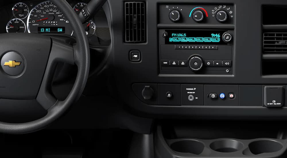 A close up of the dashboard in a 2022 Chevy Express Van is shown during a fleet sales event.