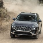 A grey 2022 Hyundai Santa Fe is shown from the front going down a dirt road after leaving a used Hyundai dealership near you.