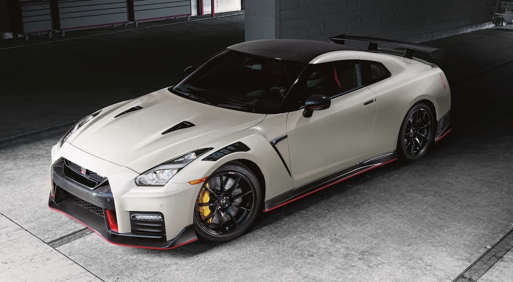 A white 2022 GT-R Nismo is shown parked in a garage after leaving a Nissan dealership.
