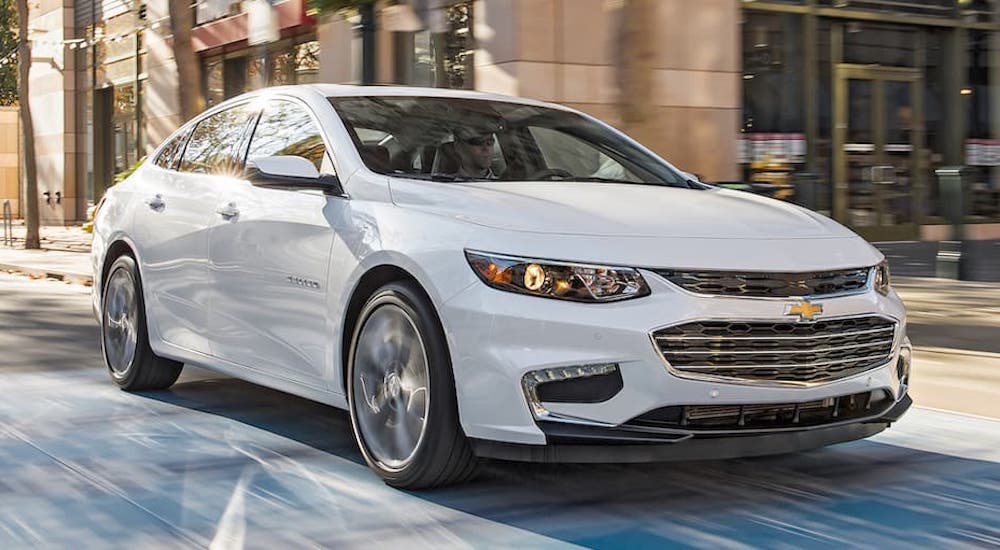 A white 2016 Chevy Malibu is shown from the front at an angle.