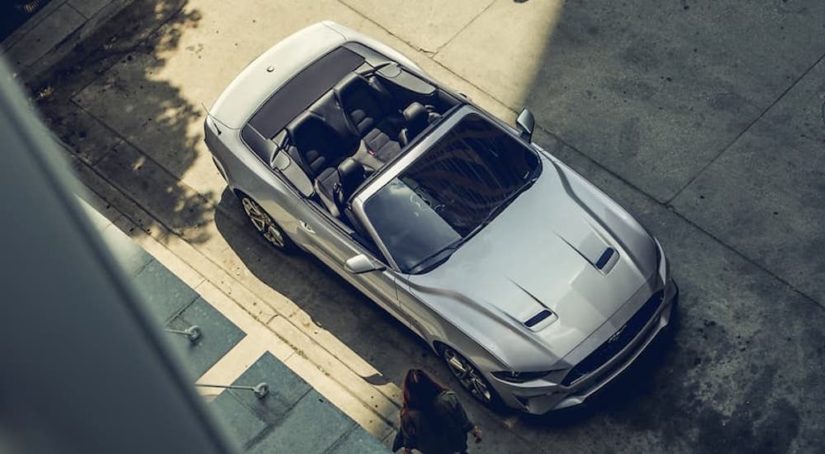 A silver 2022 Ford Mustang Convertible is shown from a high angle during a 2022 Ford Mustang vs 2022 Chevy Camaro comparison.