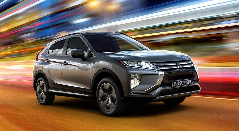 A grey 2022 Mitsubishi Eclipse Cross is shown from the front at an angle.