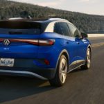 A blue 2022 Volkswagen ID.4 electric vehicle is shown from the rear while it drives down the highway.