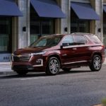 A maroon 2022 Chevy Traverse High Country is shown parked on the side of a city street.