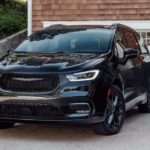 A black 2022 Chrysler Pacifica is shown from the front parked in a driveway.