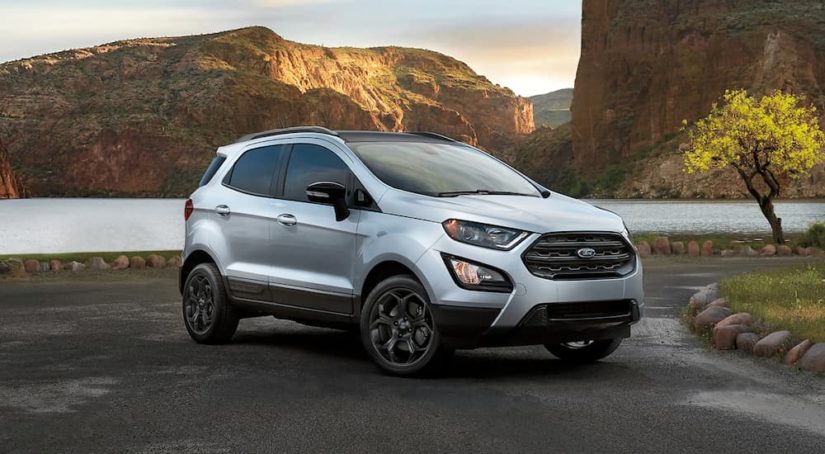 A silver 2022 Ford EcoSport SES is shown parked by a lake.