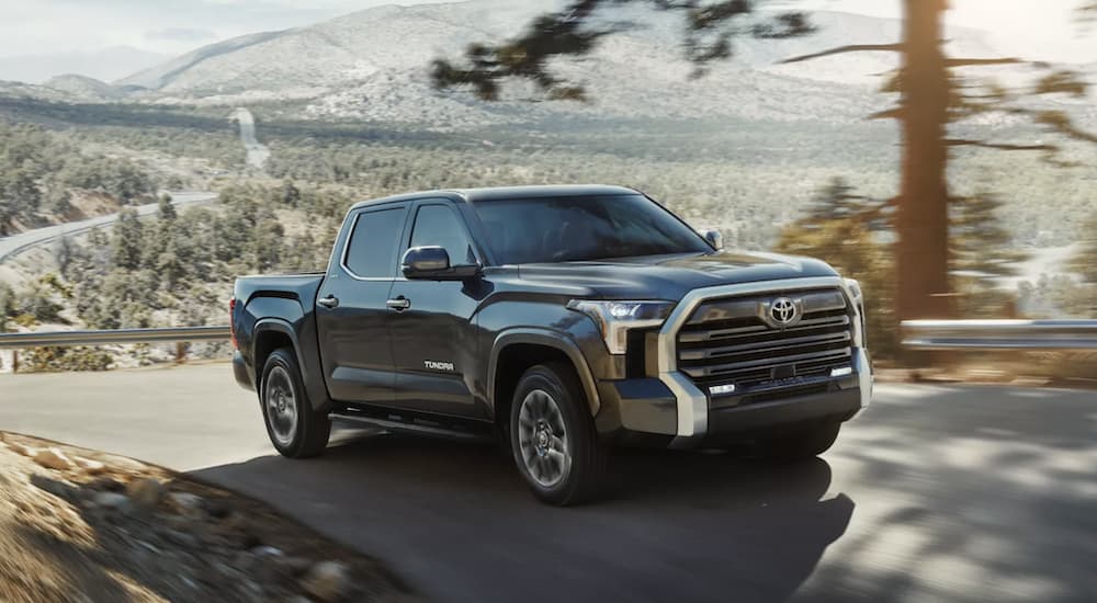 A silver 2022 Toyota Tundra Limited is shown from the front driving up a hill.