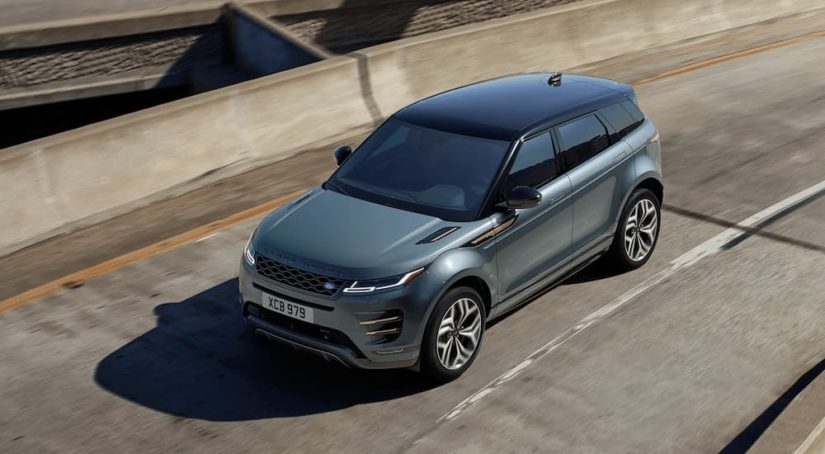 A grey 2022 Ranger Rover Evoque R Dynamic is shown driving on a highway.