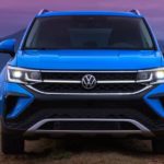 A blue 2022 Volkswagen Taos is shown from the front during a 2022 Volkswagen Taos vs 2022 Kia Seltos comparison.