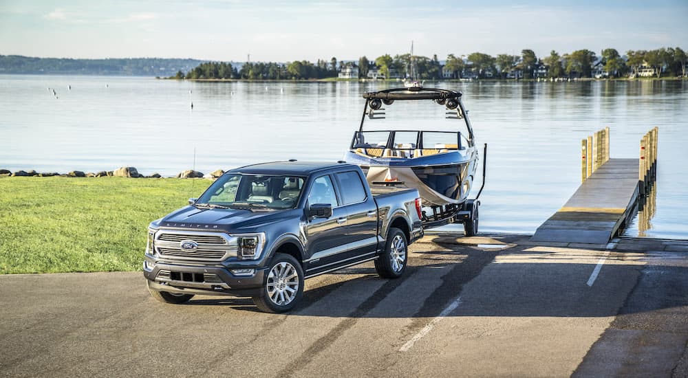 A grey 2022 F-150 is shown from the front loading a boat on a boat ramp.
