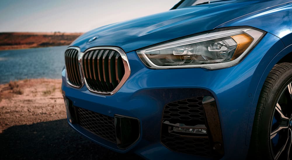 A close up of the front of a blue 2022 BMW X1 is shown.