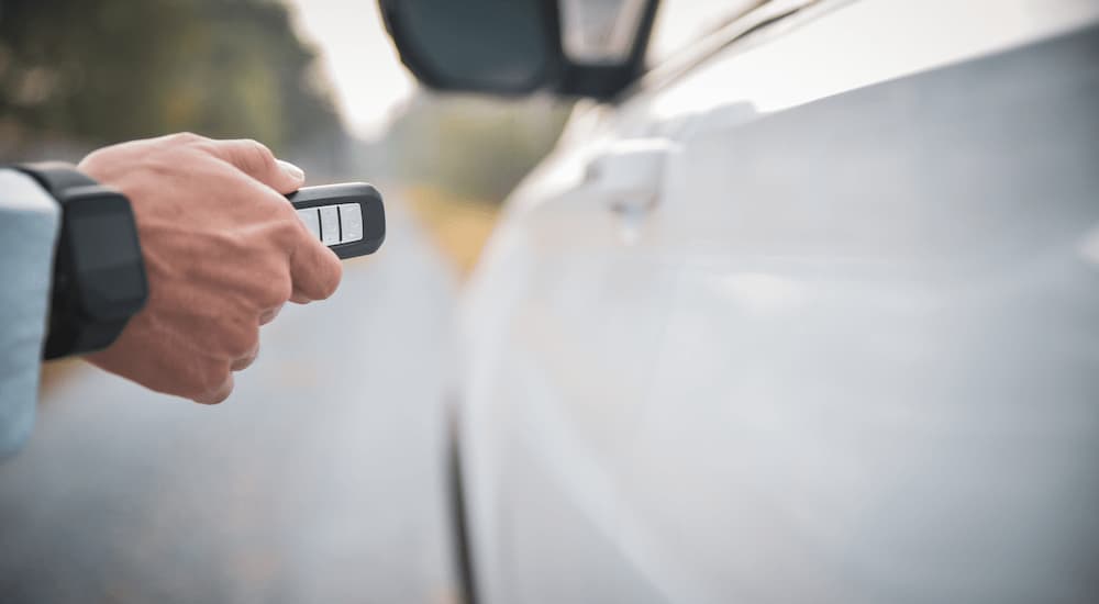 A person is shown using keyless car entry.