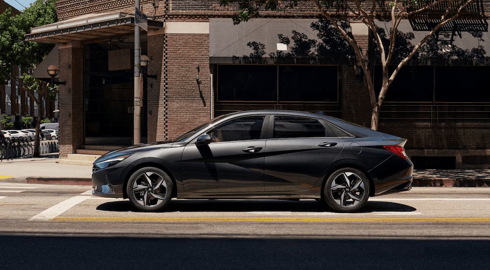 A grey 2021 Hyundai Elantra is shown from the side while on a city street.