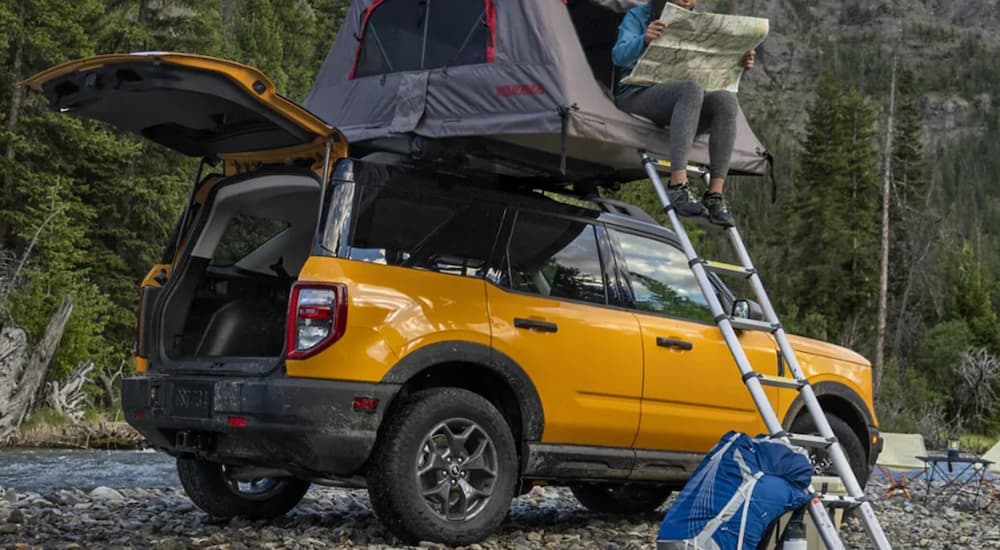 A yellow 2022 Ford Bronco Sport is shown from the side while set up for over-landing.
