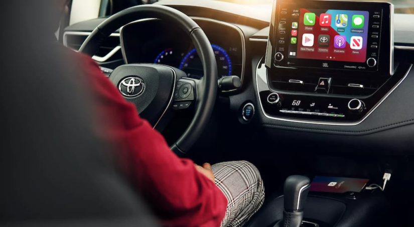 The steering wheel and infotainment screen in a 2021 Toyota Corolla XSE is shown.