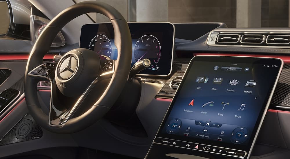 The steering wheel and infotainment screen on a 2022 Mercedes S-Class is shown at a used car dealer near you.
