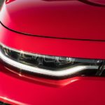 A close up shows the passenger headlight on a red 2020 Kia Soul after visiting a used Kia dealership.