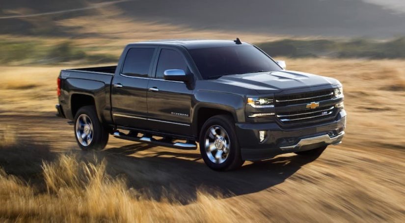 A black 2018 Chevy Silverado 1500 is shown after leaving a used truck dealer.