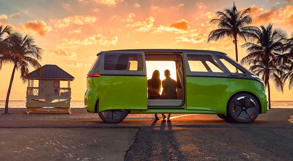 A green 2022 Volkwagen ID.Buzz is shown parked at a beach near a Volkswagen dealership near you.