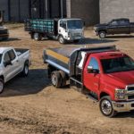 A fleet of Chevy trucks are shown at a construction site after searching 'commercial truck sales.'