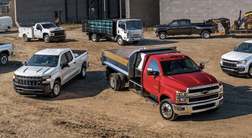 A fleet of Chevy trucks are shown at a construction site after searching 'commercial truck sales.'