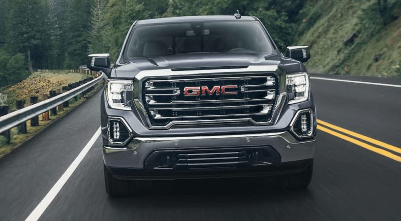 A silver 2022 GMC Sierra 1500 is shown from the front after leaving a truck dealer.